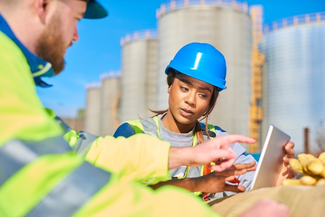 A female construction worker looking at plans