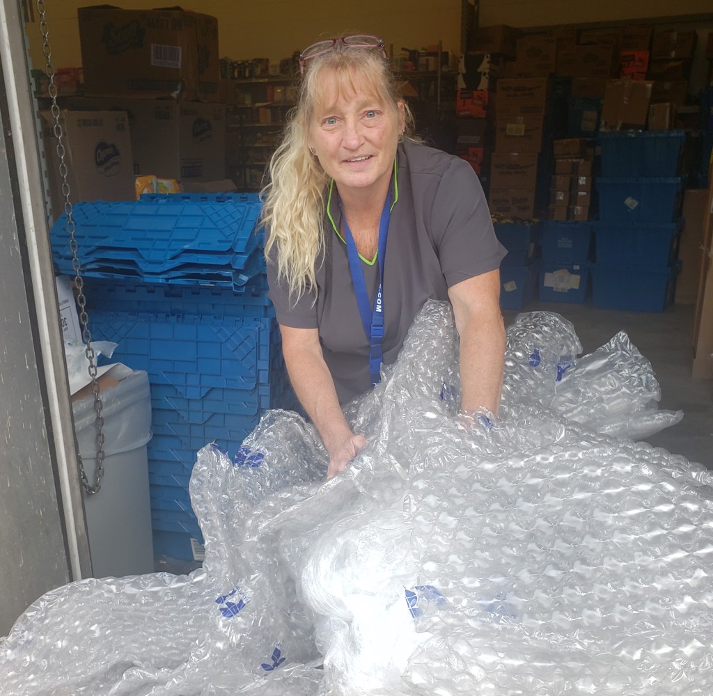 A lady gathering plastic