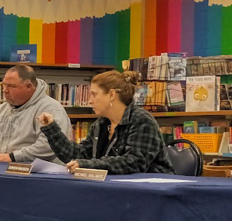 A woman speaking at aboard meeting