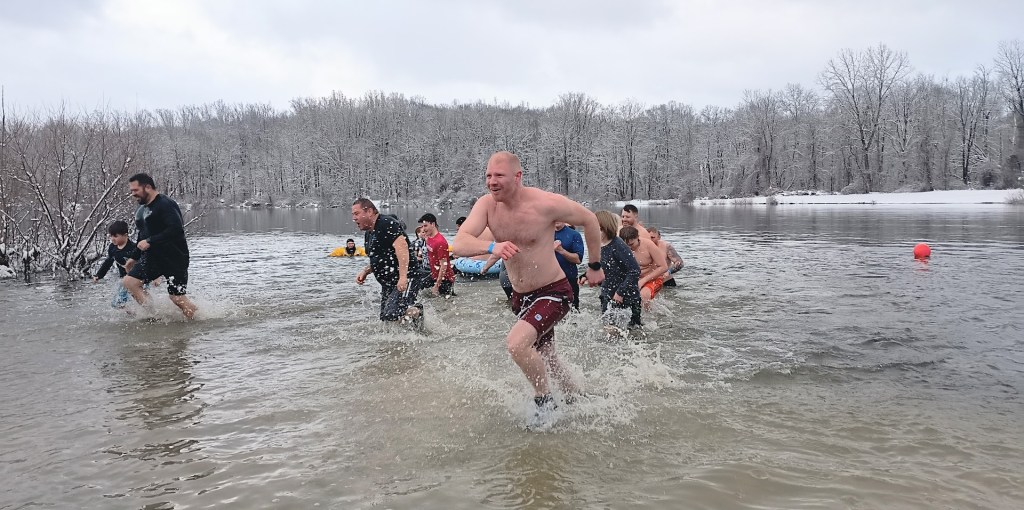 People running out of a cold lake.